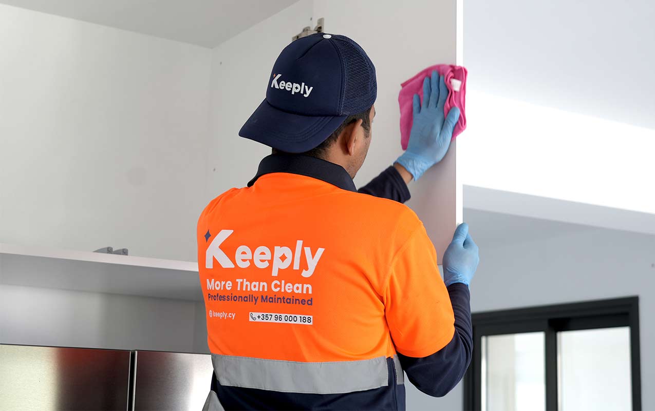 keeply employee cleaning the closets of a kitchen