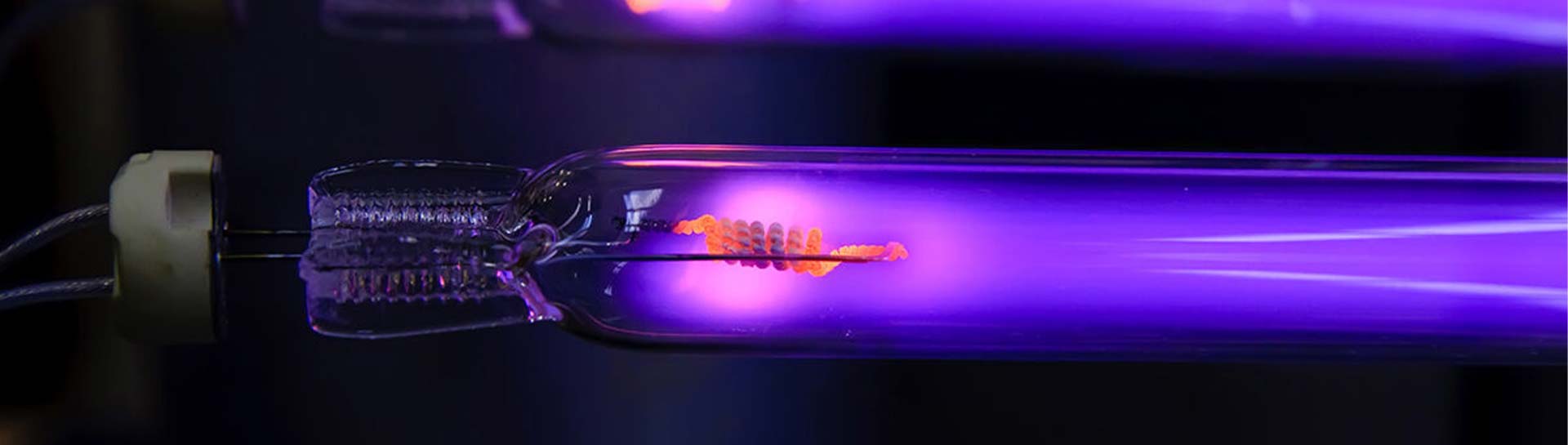 A close up of a glowing UVC lamp emitting a vibrant purple light 