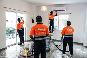 keely team in uniform cleaning glass, AC vents, and floor with keeply tools and machines in a residence