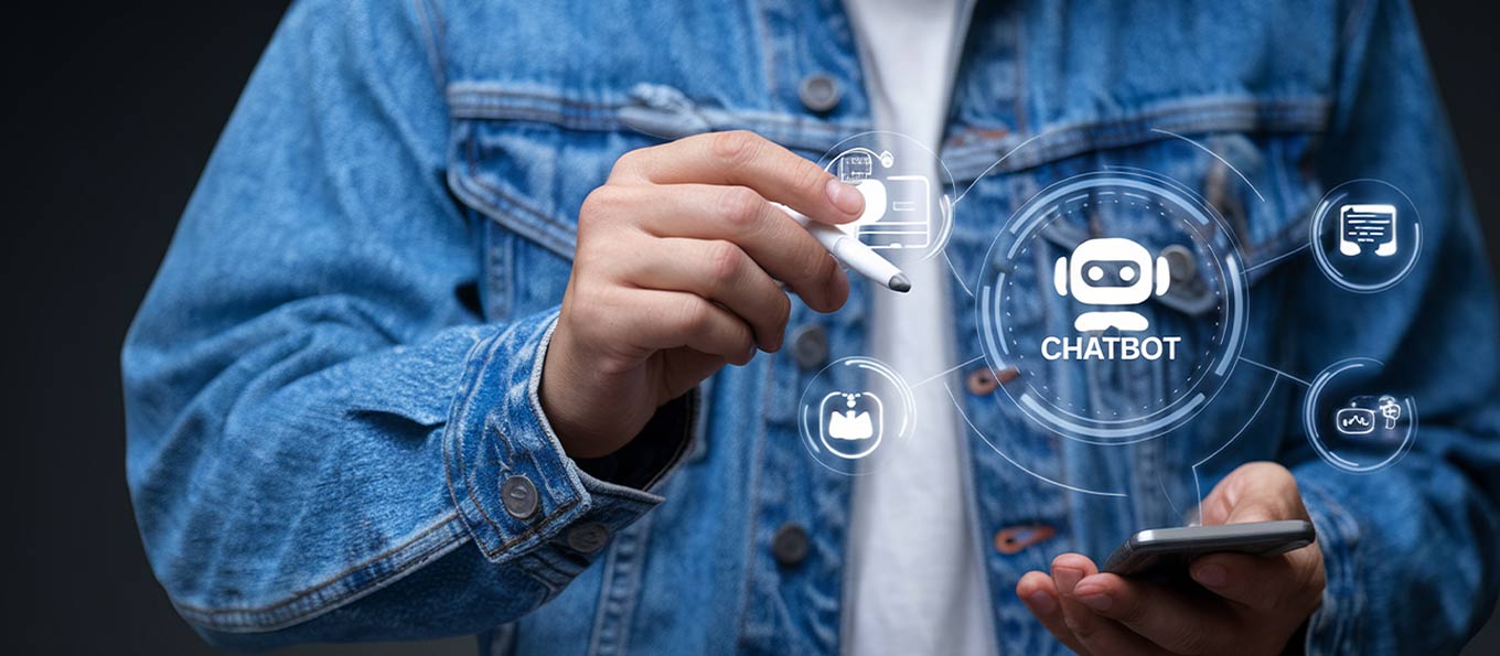 Close-up of a person in a denim jacket using a stylus and smartphone to interact with a glowing digital chatbot interface and communication icons