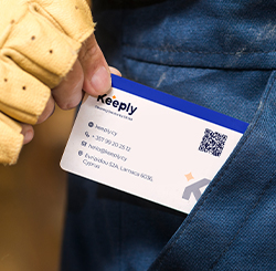 close up image of keeply bussiness card being pulled out of keeply employee pocket