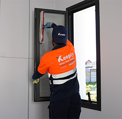 keeply employee cleaning the widnows glass using a glass brush tool