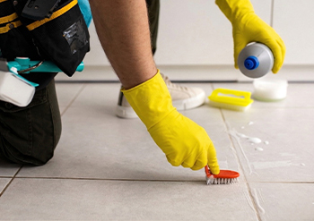 keeply employee vacuuming the dust from a house 