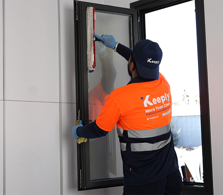 A professional keeply employee applying a wash sleeve to a window frame