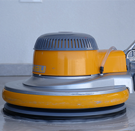 A close-up of a Ghili floor polishing machine head used for professional floor cleaning services.