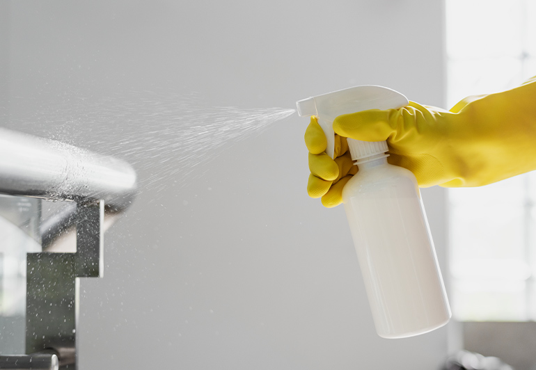 a close up of a specialized chemical spray bottle spraying chemical solution used by keeply employee. 