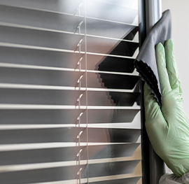 close up of clean filter and keeply employee's hand putting final touches of cleaning on the filter.