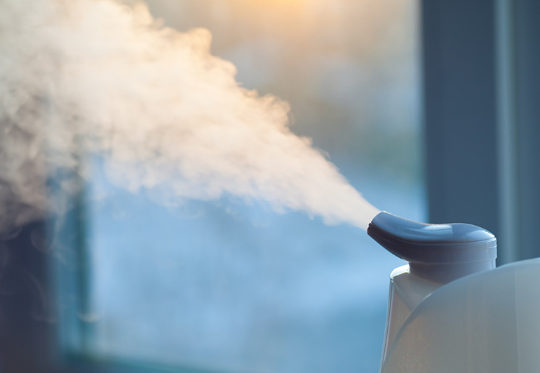 close up of an ozone ionization spray bottle spraying gas to clean and sanitize the air
