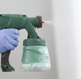 close up of a keeply employee using the ozone ionization spray bottle to clean and sanitize the air